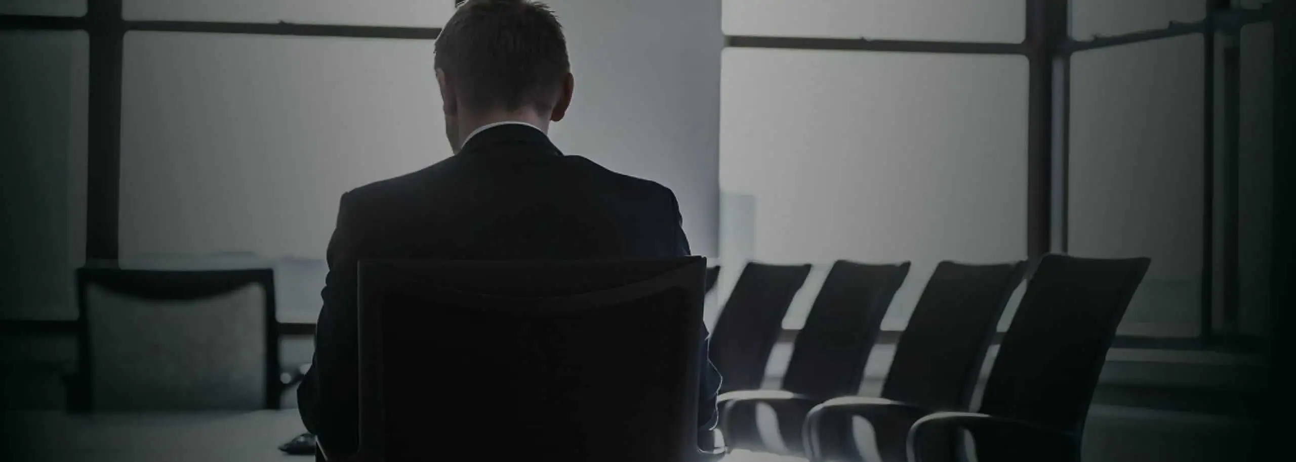 Solicitor sitting in Office Boardroom